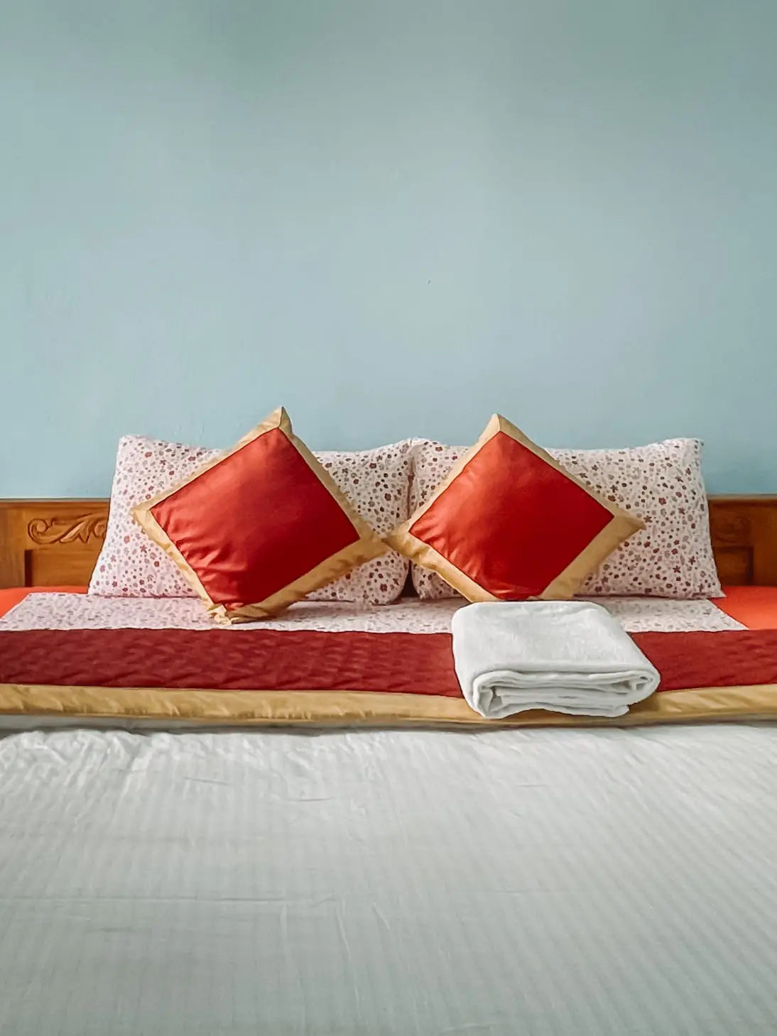 The Cozy Room: cushions and folded towels on the bed