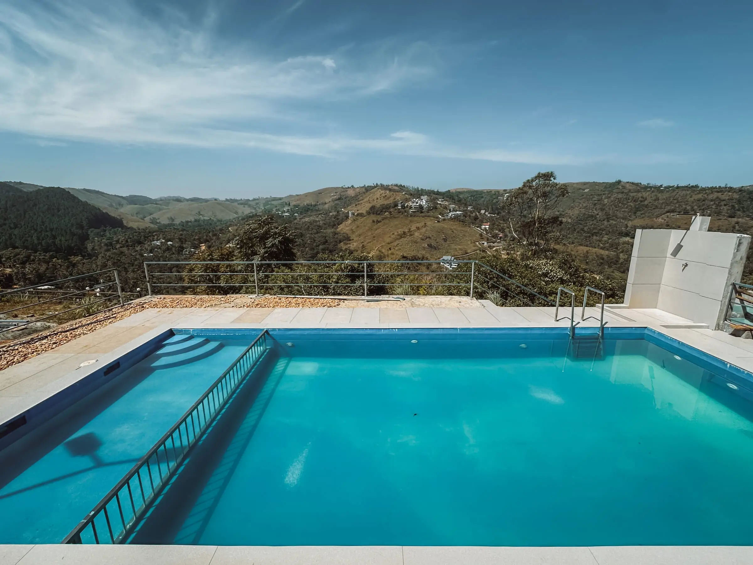 The open-air pool and its deck, looking out over the hills