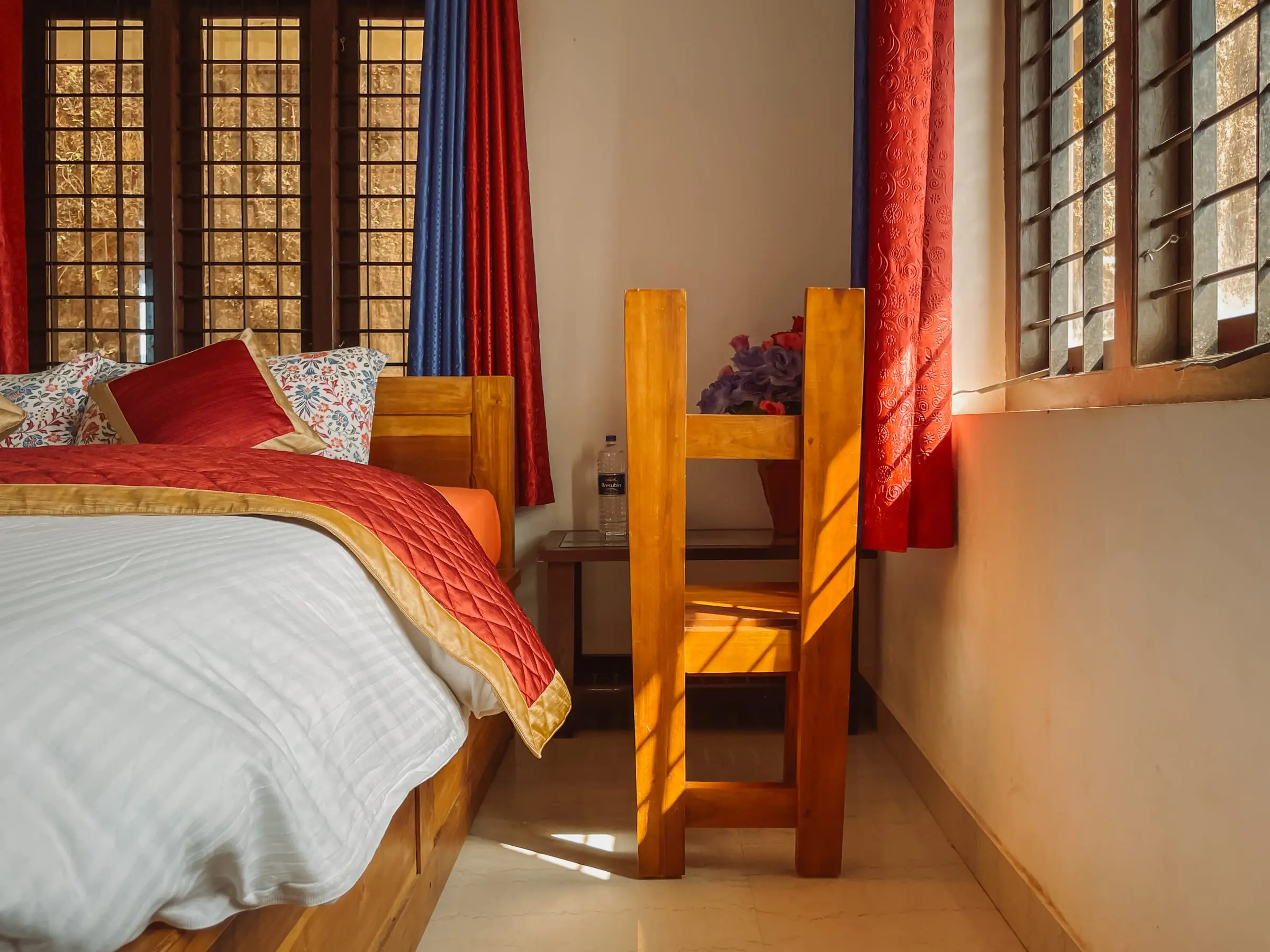 The Comfort Suite: bedside and window seat in warm light